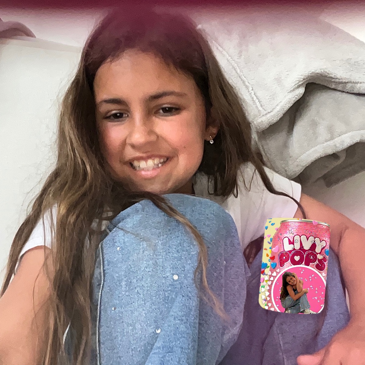 Olivia Mehran smiling with a pink Livy Pops soda can